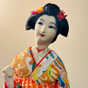Vintage Exotic Geisha Doll Japanese Ornament.  In Great Condition.  The Height is 14 inches and Width is 4 inches.