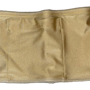 May include: A gold-colored, rectangular fabric item with a slightly shiny finish. The edges are finished with a ribbed, textured material. Vertical seams divide the fabric into three sections.