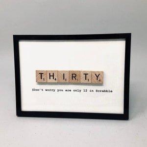 May include: A framed print with the word "THIRTY" spelled out using Scrabble tiles. The text below the tiles reads "(Don't worry you are only 12 in Scrabble".