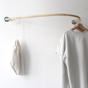 curved wooden clothes rail