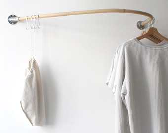curved wooden clothes rail