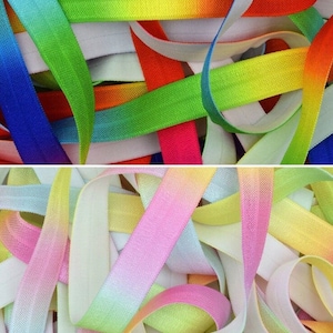 May include: A close-up of a pile of colorful elastic ribbon. The ribbon is ombre, with a white base and a gradient of color. The colors include pink, yellow, green, blue, and red.