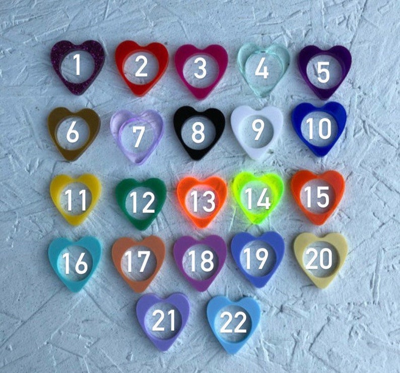 May include: Twenty-two heart-shaped resin blanks in various colors, numbered 1 through 22. The blanks are arranged in rows, with the first row containing five blanks, the second row containing six blanks, the third row containing five blanks, and the final row containing two blanks.