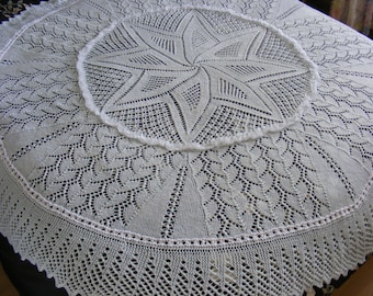 May include: A white crocheted shawl with a circular design featuring a star in the centre.
