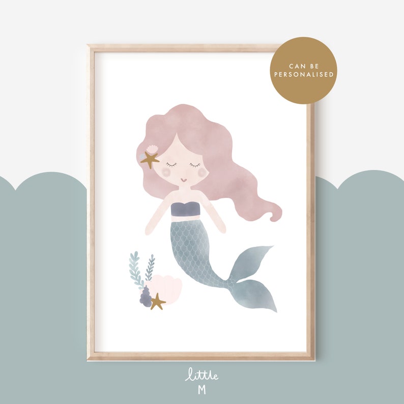 May include: A watercolour illustration of a mermaid with pink hair and a blue tail. She is surrounded by seashells and seaweed. The image is framed in a light wood frame.