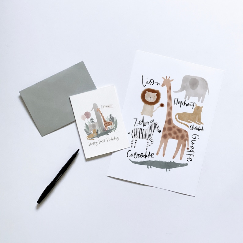 May include: A card with a giraffe, zebra, lion, elephant, cheetah, and crocodile. The card says "Happy First Birthday" and "one".