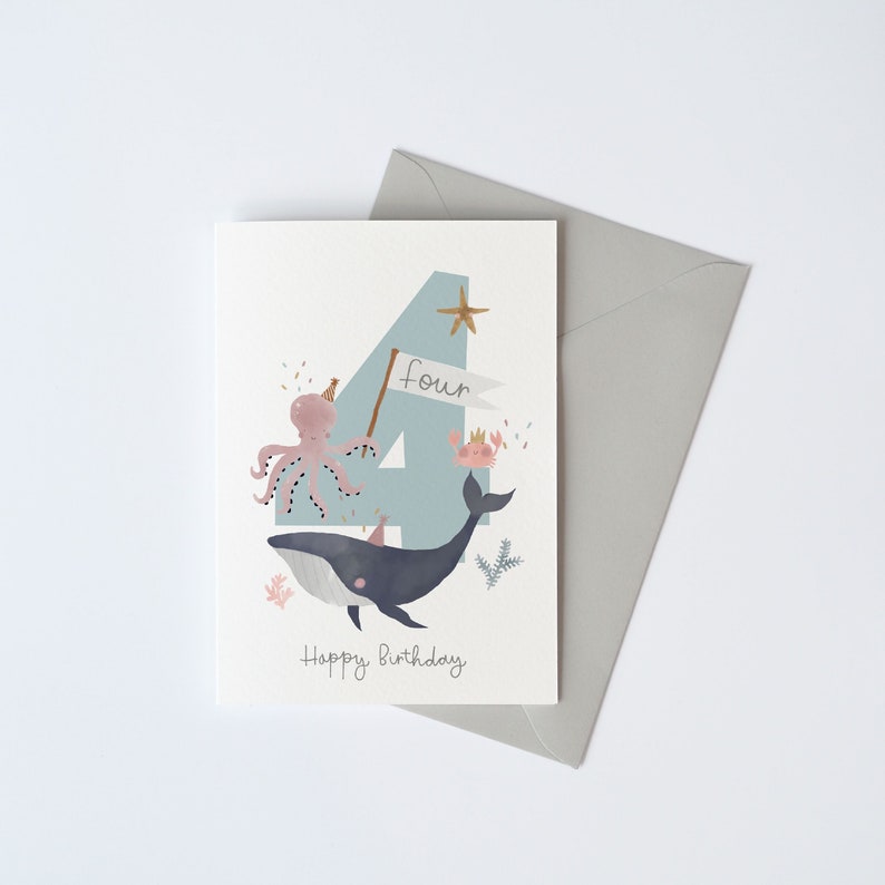 May include: A light blue card with a large number four on it. The number is decorated with a whale, an octopus, and a crab. The text "four" and "Happy Birthday" are written on the card.