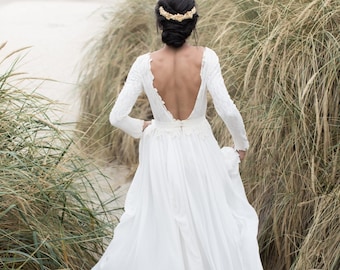 Open-back wedding dress with lace-lined bodice and a flowy skirt