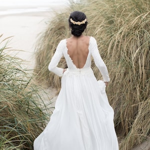 Open-back wedding dress with lace-lined bodice and a flowy skirt