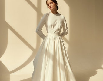 Modest cotton wedding dress with high-neck bodice and draped skirt