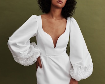 Vintage inspired satin custom wedding dress with v-neck bodice and puffed sleeves