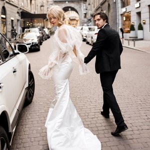Fitted satin wedding dress with bouffant sleeve bolero
