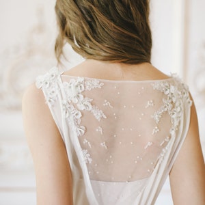 Off-white wedding gown with sheer embroidered back