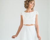 Crop top two piece wedding dress with cap sleeve lace top and flowing blue skirt