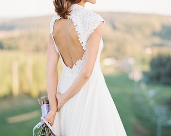 Off-white open back wedding dress with lace bodice