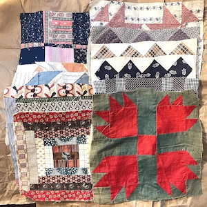May include: A collection of antique quilt blocks in various patterns and colors. The blocks feature patchwork designs with floral, geometric, and striped fabrics. One block has a red bear paw design on a green background.