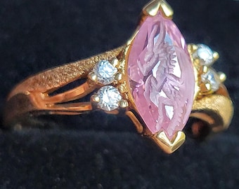 10k gold ring set with a synthetic pink stone carved with an intaglio dragon and diamonds