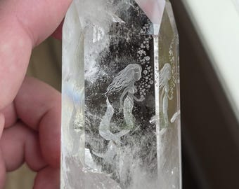 mermaid carved reverse intaglio on to a polished quartz crystal tower with chlorite phantom inclusion