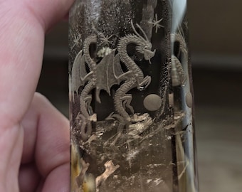 dragon reverse intaglio carved onto a polished smokey quartz tower