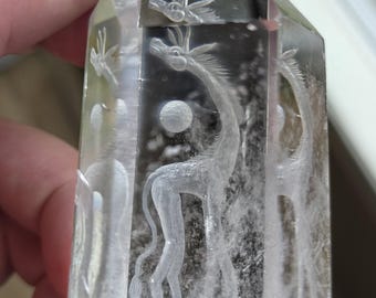 giraffe reverse intaglio carved onto a polished quartz crystal tower