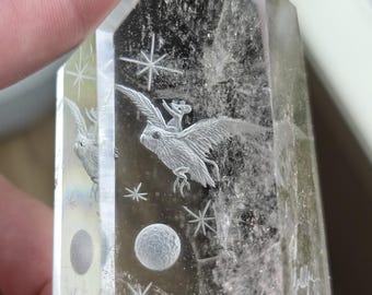 owl with a rat on its back carved reverse intaglio onto a polished quartz crystal