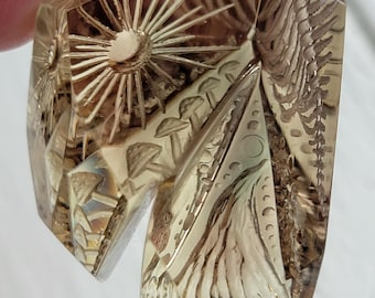 105 carat reverse intaglio carved oregon sunstone with surrealistic imagery