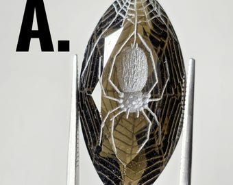 1x spider with web on front and back carved onto marquis cut smokey quartz