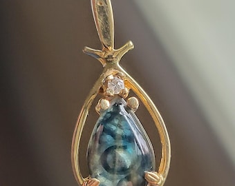 sapphire reverse intaglio carved dragon eye set in small 14k gold setting with diamond accent