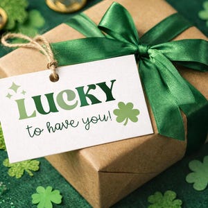 May include: A wrapped gift box with a green ribbon and a tag that reads "LUCKY to have you!" in green lettering. The background includes shamrock decorations and gold coins, creating a festive St. Patrick's Day theme.