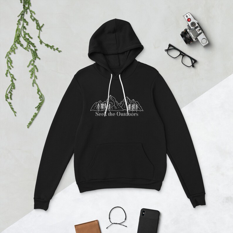 May include: Black hooded sweatshirt with a white outline of mountains and trees. The text "Seek the Outdoors" is printed below the image.