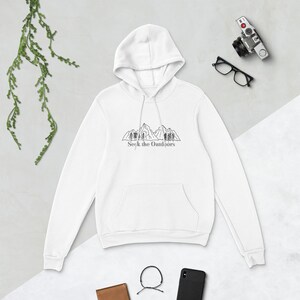 May include: White hooded sweatshirt with a black mountain range and trees graphic and the text "Seek the Outdoors" printed on the front.