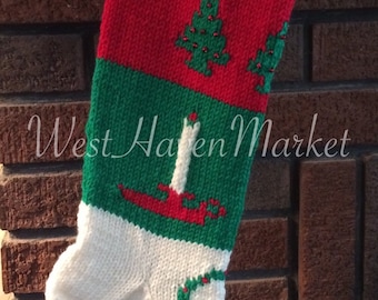 May include: A knitted Christmas stocking with the name "MELIN" in green letters on a white background. The stocking features red, green, and white sections with Christmas tree and candle designs. A gold bell hangs from the top.
