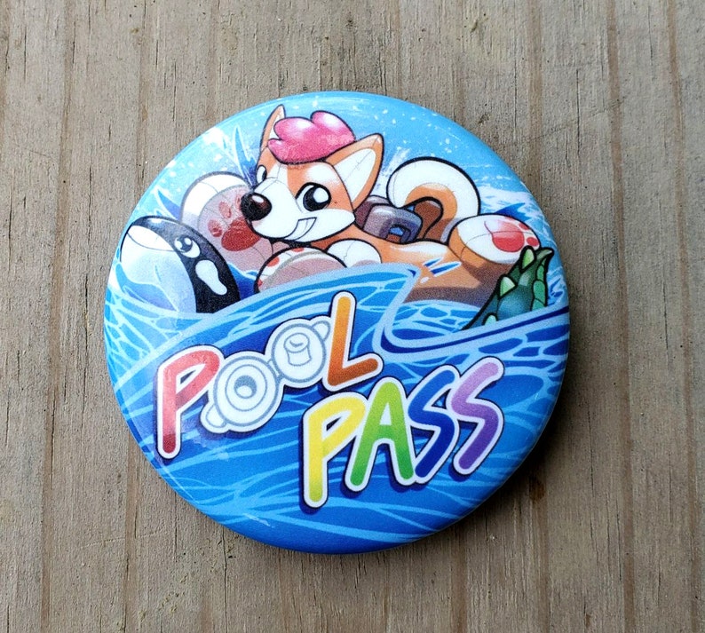 May include: A blue and white button with a cartoon dog wearing a life preserver and the text "Pool Pass" in rainbow colors.