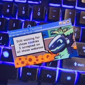 May include: A blue and green cartoon character with a helmet and a blue background. The text on the image says "Still waiting for those cookies I accepted on all those websites".