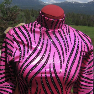 May include: A pink and black zebra print long-sleeved shirt with rhinestones.