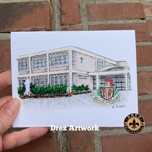 May include: A hand-drawn illustration of a school building with a cross on the roof. The building is labeled "Brother Martin High School". The illustration is in black and white with some color accents. The artist's signature is in the bottom right corner.