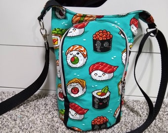 Op de afbeelding: Een turquoise blauwe schoudertas met een verstelbare zwarte band. De tas is versierd met een herhalend patroon van cartoon sushi rollen.