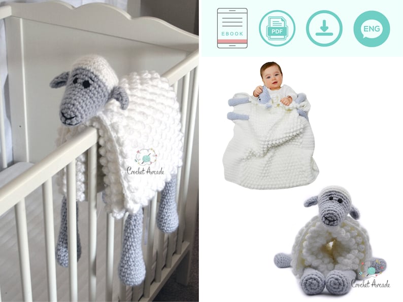 Pu&ograve; includere: Una coperta a uncinetto bianca e grigia a forma di pecora con testa e gambe di pecora grigie. La coperta &egrave; appesa a un lettino bianco. L'immagine include il testo "Crochet Arcade".