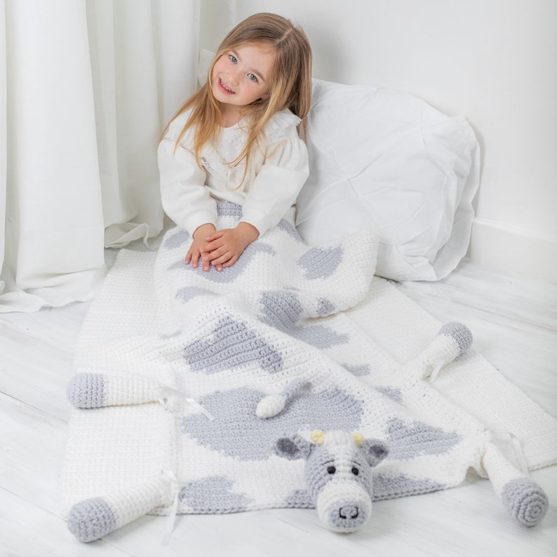Crochet cow baby blanket that folds into crochet toy cow. PDF crochet pattern to make a cow blanket as baby shower gift. Crochet pattern to make a blanket for babies, children, teens and adults.