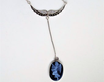This necklace has angel wings with cs's and a carved cameo of an angel into a blue (black) agate all sterling silver