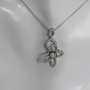 Butterfly pendant encrusted with cz sterling and has a hand carved cameo by Carla