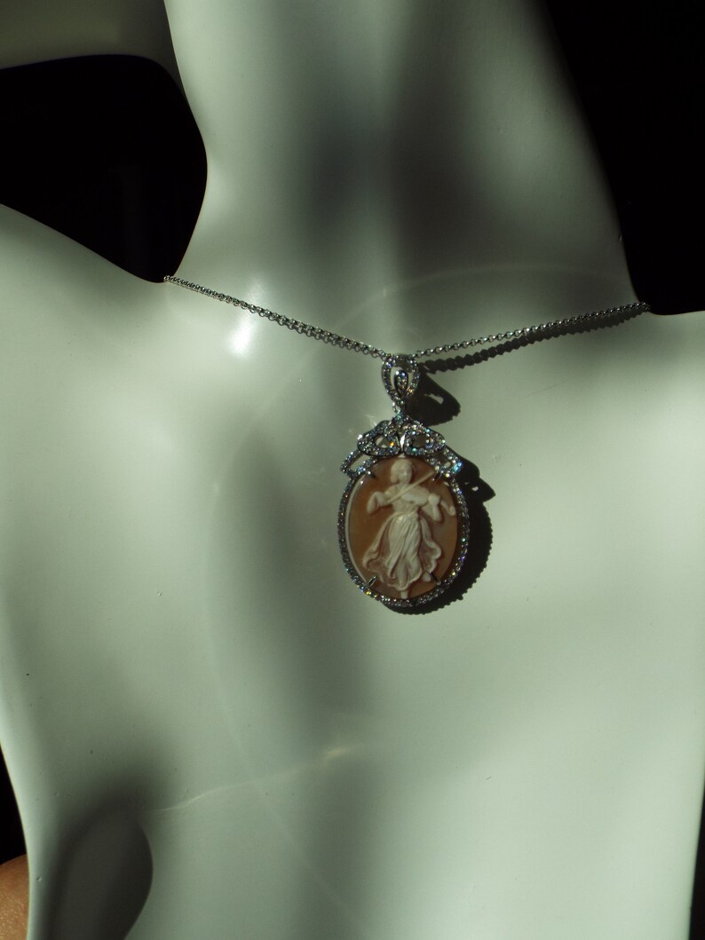 Master hand carved sardonyx cameo set into sterling silver pendant with cubic zirconia