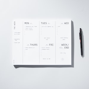 May include: A weekly planner with a black and white design. The planner has a section for each day of the week, Monday through Sunday. The days are labeled with the abbreviations "MON", "TUES", "WED", "THURS", "FRI", "SAT", and "SUN". The planner also has a section for "WEEK/END".