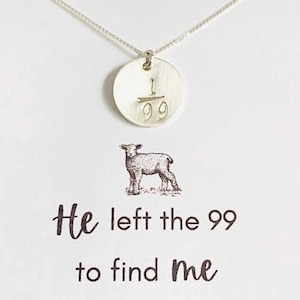 May include: A silver necklace with a round pendant featuring the numbers "1/99". The pendant hangs from a delicate chain. Below the pendant is a card with a lamb illustration and the text "He left the 99 to find me" and "Matthew 18:12-14".