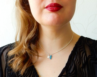 Silver cherub necklace with blue agate pendant