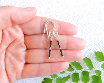 Dangling earrings with small black spinel beads on sterling silver wire