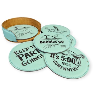 May include: Set of six light blue round coasters with black text and images. The coasters feature phrases like "Keep the Party Going!" and "It's 5:00 Somewhere".