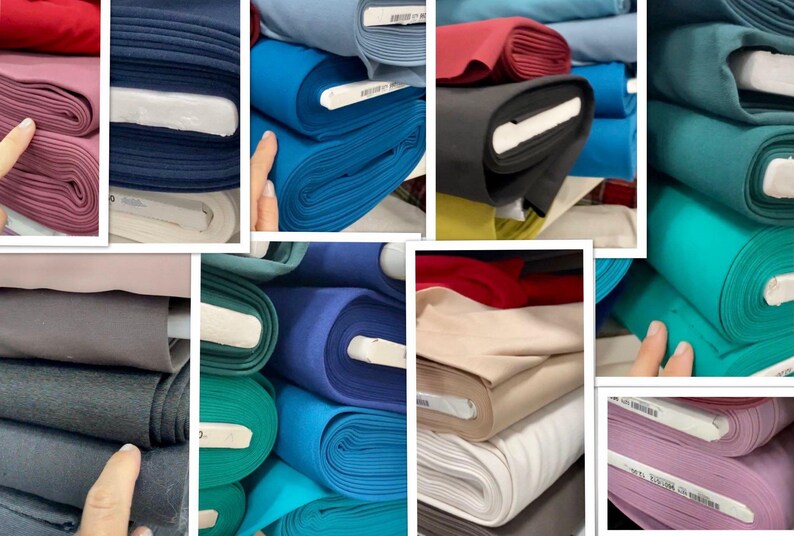 May include: A collection of fabric rolls in various colors, including pink, navy blue, teal, red, black, and beige. The fabric is neatly rolled and stacked, showcasing a variety of textures and hues. Ideal for sewing and crafting projects.