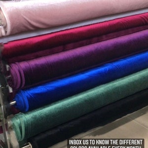 May include: Close-up of six rolls of velvet fabric in different colors, including pink, red, purple, blue, green, and black. The text "INBOX US TO KNOW THE DIFFERENT COLORS AVAILABLE EVERY MONTH" is visible at the bottom of the image.