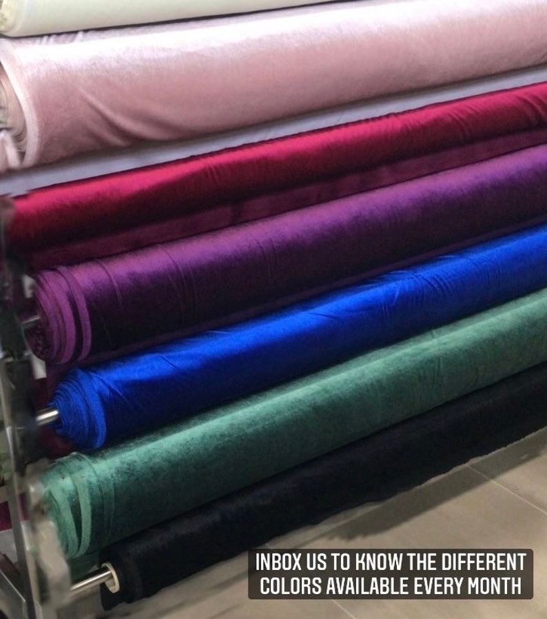 May include: Close-up of six rolls of velvet fabric in different colors, including pink, red, purple, blue, green, and black. The text "INBOX US TO KNOW THE DIFFERENT COLORS AVAILABLE EVERY MONTH" is visible at the bottom of the image.
